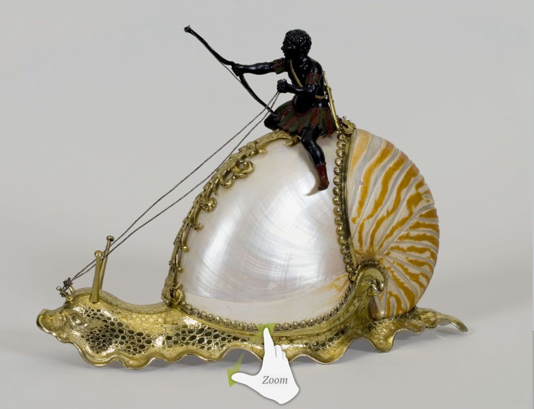 A figurine of a man riding on a snail