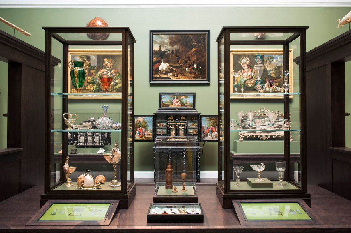 A room with a collection of items in glass cases.