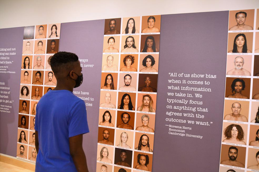 A man staring at a wall of faces