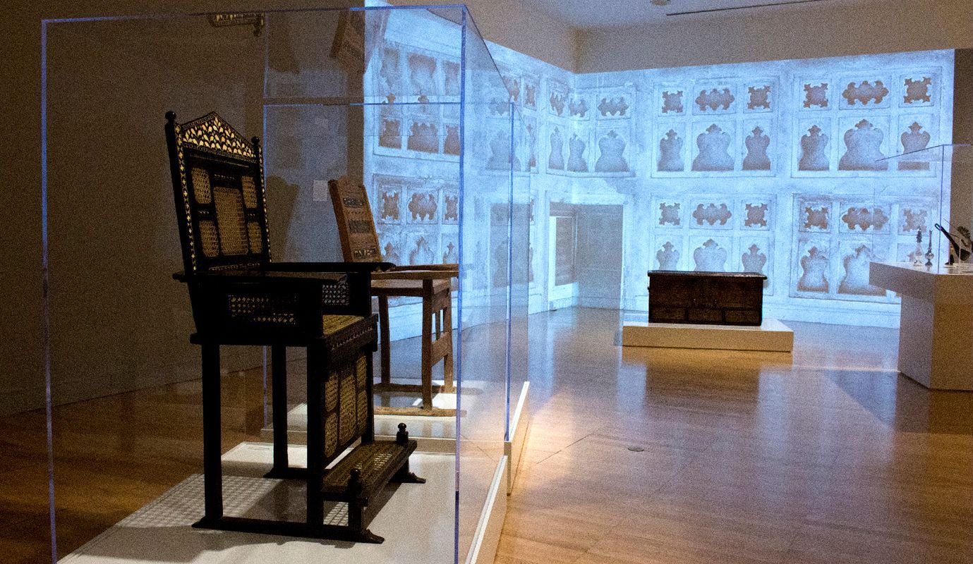 A museum with a display of chairs.