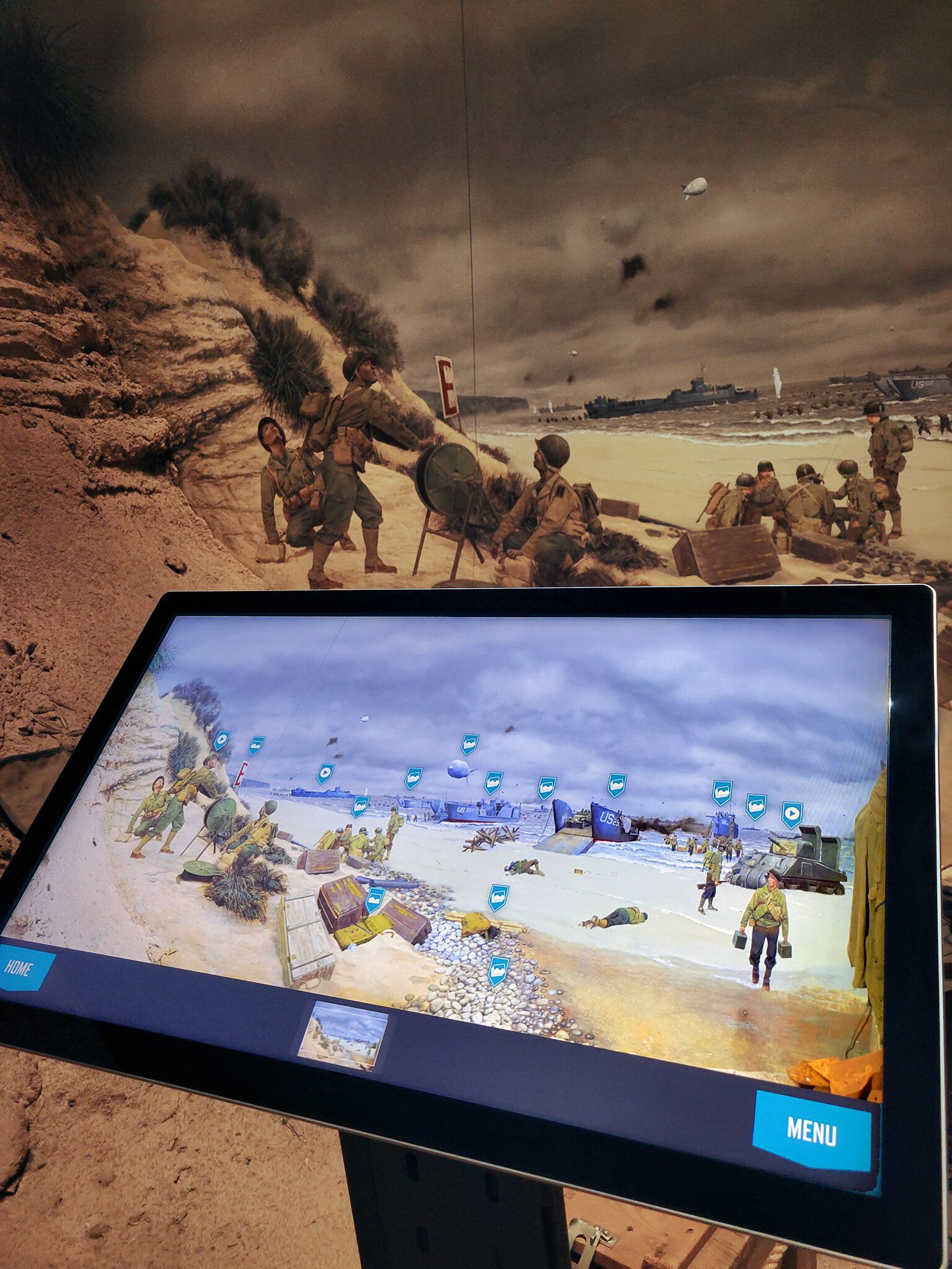 A touchscreen kiosk in a Normandy beach exhibit