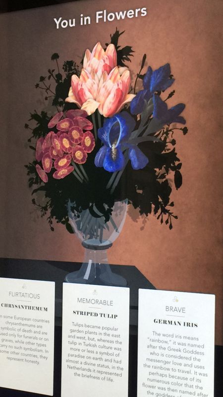 A screen with a picture of flowers in a vase.
