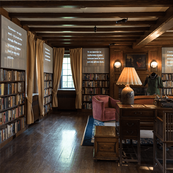 Text projected on screens above several shelves.